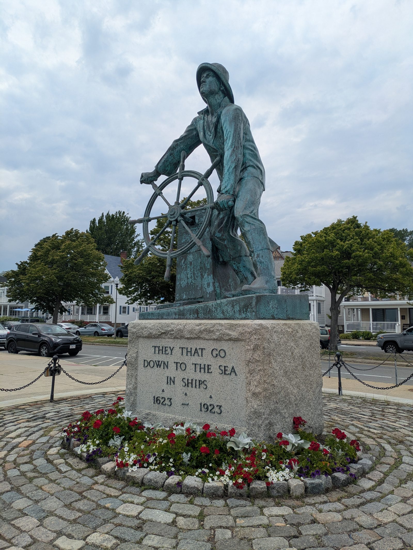 A statue of a man at the wheel of a fishing boat