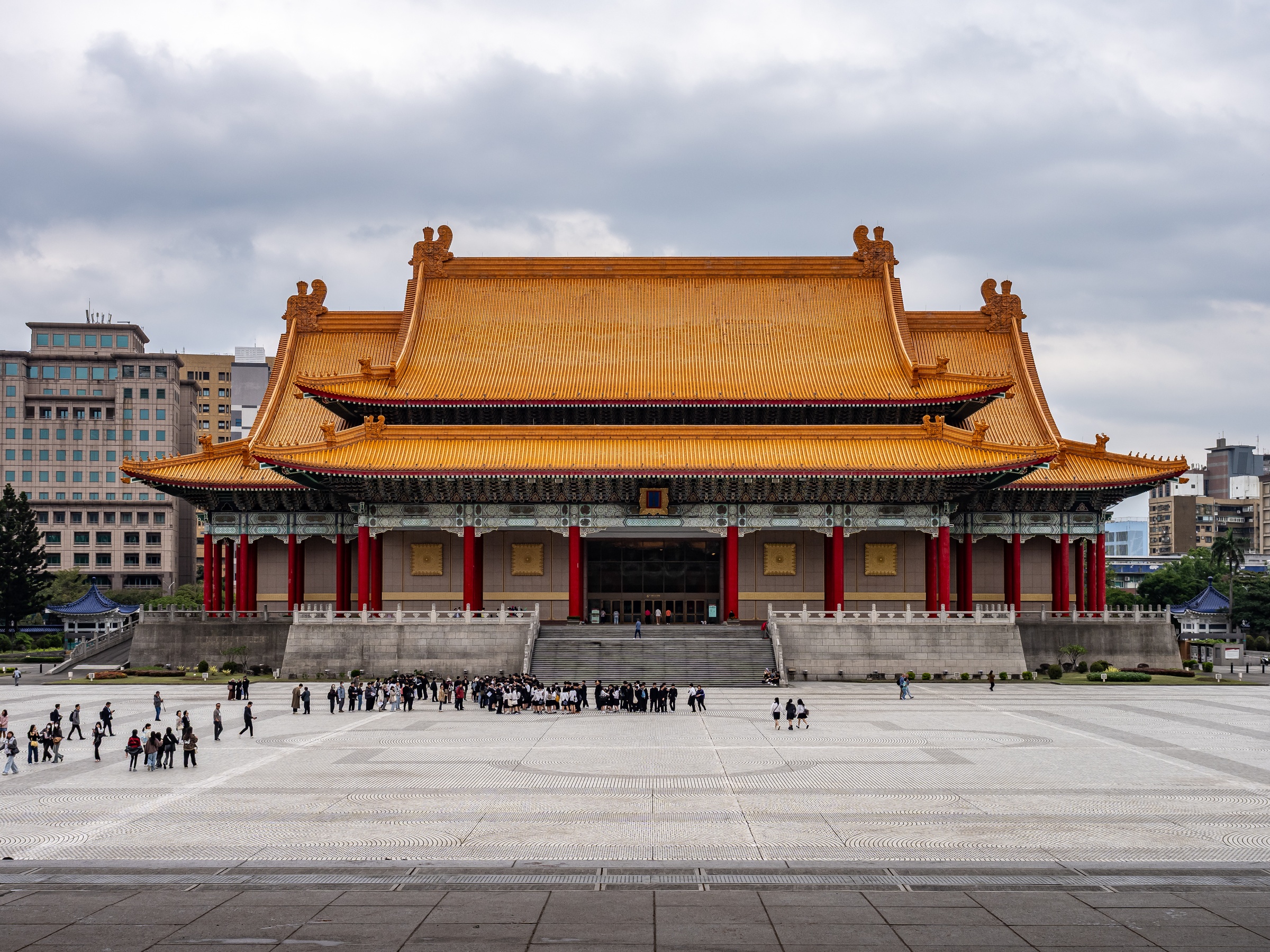 The National Chiang Kai-shek Memorial Hall stands on a large plaza under an overcast sky.