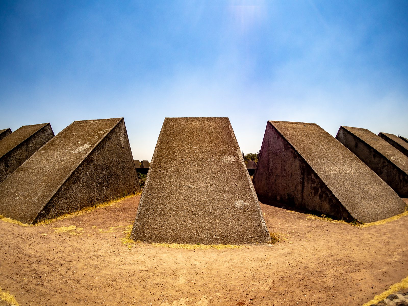 Stone wedges arranged in a circle facing inward reach for the sky.